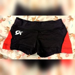 Black and red GK Elite gymnastics workout shorts. Size Child Medium (CM).